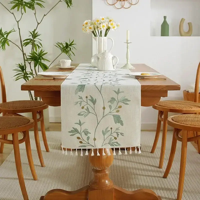Embroidered cotton linen table runner with tassel details for dining table décor